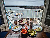 Savoring a delicious homemade brunch with coffee, eggs, and fresh fruit overlooking the beautiful waters of Lanzarote.
