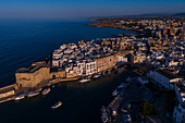 Aerial view of Porto Antico, the historic old port, the Marina, Castello Carlo V and the old town, Monopoli, Italy