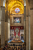 Seville, Spain, March 1st 2019, Visitors admire the elaborate Baroque Altar del Jubileo, a stunning centerpiece within Seville Cathedral showcasing silver craftsmanship.