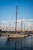 Sailing boats at sunset in Barcelona Port Vell Marina, Barcelona, Spain