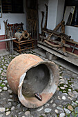 A vintage ceramic dye pot & farm equipment at the Tahuantinsuyo Weaving Workshop, Otavalo, Ecuador.