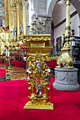 An ornate gilded lectern in the sacristy of the Quito Metropolitan Cathedral in Quito, Ecuador.