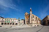 Visitors enjoy the vast Renaissance Plaza Mayor in Trujillo, surrounded by historic palaces and the impressive church of San Martin.
