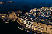 Aerial view of Porto Antico, the historic old port, the Marina, Castello Carlo V and the old town, Monopoli, Italy