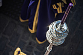 Aerial view of a processional candle featuring a striking purple candle amidst the vibrant atmosphere of Holy Week in Seville, Andalusia.