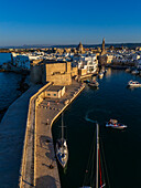Aerial view of Porto Antico, the historic old port, the Marina, Castello Carlo V and the old town, Monopoli, Italy