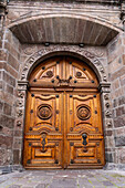 Carved wooden doors at the northwest end of the Metropolitan Cathedral of Quito, Ecuador.