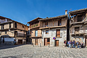 Garganta la Olla, Spain, Jan 10 2015, Visitors explore the charming streets of Garganta la Olla, admiring picturesque timber-framed houses and an inviting arcaded square.