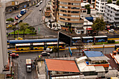 MetrobusQ buses on the Ecovia Line at a bus stop on Avenida 6 de Diciembre in the northern sector of Quito, Ecuador.