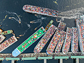 Aerial view of bustling Eid al-Fitr celebration with colorful boats and crowded river activity, Subhadya, Keraniganj, Dhaka, Bangladesh.