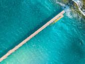 Aerial view of jetty and pier over blue water and reef, Port Noarlunga, South Australia, Australia.