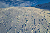Aerial view of beautiful Auron winter sports resort with snow-covered ski tracks and serene mountains, Alpes Maritimes, France.