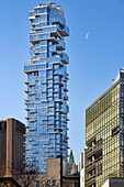 Aerial view of modern skyscrapers and urban landscape under a blue sky, New York City, New York, United States.