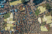 Bogura, Bangladesh - 27 November 2019: Aerial view of a bustling marketplace teeming with vibrant activity, where vendors display their wares in organized chaos.
