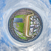Aerial view of a tiny planet perspective of Hull with residential and industrial buildings surrounded by greenery and fields, England, United Kingdom.