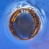 Aerial view of a tiny planet perspective of the skyline and buildings surrounding the Thames River at dusk, London, England, United Kingdom.