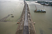 Aerial view of scenic Padma Bridge over the clear Padma River in urban landscape of Austagram, Dhaka, Bangladesh.