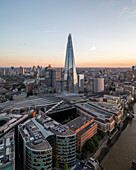 Aerial view of the shard skyscraper and city skyline at sunset over the River Thames, London, England, United Kingdom.