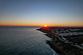 Aerial view of beautiful sunset over the coastline and beach, Algave, Portugal.