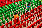 Araihazar, Bangladesh - 04 December 2020: Aerial view of colorful fabrics dyeing workshop with workers in rows, Satgram, Araihazar, Dhaka, Bangladesh.