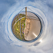 Aerial view of a tiny planet perspective of a beautiful suspension bridge over a river with clouds in the sky, Hessle, England, United Kingdom.