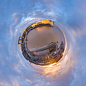 Aerial view of a tiny planet perspective of historic Old Town with beautiful buildings and water under a sunset sky, Hull, England, United Kingdom.