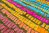 Araihazar, Bangladesh - 04 December 2020: Aerial view of vibrant fabrics dyeing process with colorful patterns and people working in the field, Satgram, Araihazar, Dhaka, Bangladesh.