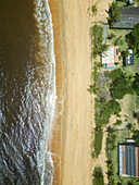 Aerial view of praia rio caraiva with beautiful sandy beach, tranquil ocean waves, and lush palm trees, Caraiva, Bahia, Brazil.