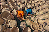 Bogura, Bangladesh - 29 October 2020: Aerial view of people weaving beautiful handmade baskets in a traditional craft setting, Sherpur, Bogura, Rajshahi, Bangladesh.