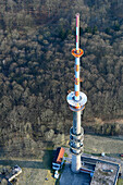 Aerial view of a tall steel mast surrounded by a scenic forest and rural landscape, Woldegk, Mecklenburg-Vorpommern, Germany.