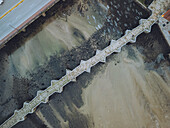 Aerial view of the historic ramallosa roman bridge over the minor river with scenic landscape and picturesque surroundings, Nigran, Pontevedra, Spain.