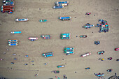 Aerial view of beautiful sandy beach with boats and people, Chittagong Kotwali Thana, Chattogram, Bangladesh.