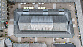 Aerial view of the historic pannier market and surrounding buildings in a vibrant town square, Tavistock, United Kingdom.