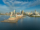 Aerial view of Navy Pier's iconic dome contrasting with the modern skyline, reflecting on Lake Michigan's serene waters, Chicago, Illinois, United States.
