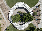 Aerial view of the Scottsdale Civic Center's iconic white structure embracing lush greenery against a backdrop of manicured lawns and geometric pathways, Scottsdale, Arizona, United States.