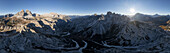 Aerial view of jagged peaks and sunlit valleys meet in a breathtaking panorama, showcasing the rugged beauty of the mountains, Belluno, Veneto, Italy.
