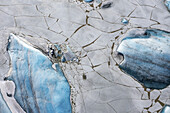 Aerial view of fractured ice creating a mosaic of whites and blues, reflecting the cold tones of the region, Selfoss, Sveitarfélagið Árborg, Iceland.