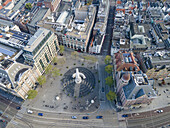 Aerial view of the bustling Spui square, with its central statue and geometric pavement patterns, nestled amidst historic buildings, Amsterdam, North Holland, Netherlands.
