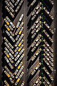 Aerial view of rows of yellow buses parked neatly, their shadows creating stark lines on the asphalt, an organised urban landscape unfolds., Poland.