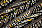 Aerial view of tightly packed yellow trams casting long shadows on the dark pavement, creating a geometric pattern of light and shade, Various places, Poland.