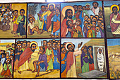 Kalacha, Kenya - 12 May 2022: View of vibrant religious frescoes depicting biblical scenes with deep earth tones and bright halos, capturing moments of faith and community in a timeless narrative.