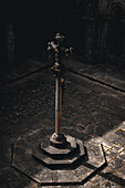 Porto, Portugal - 17 June 2022: View of an ornate stone cross bathed in soft light at the heart of the ancient courtyard, a silent sentinel of faith and history.