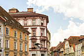 View of colorful buildings with intricate architectural details under a partly cloudy sky, showcasing the charm of European cityscapes, Graz, Graz, Austria.