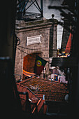 Porto, Portugal - 17 June 2022: View of the Ponte Luís I archway, where the Portuguese flag hangs proudly above the terracotta rooftops.