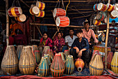 Bogura, Bangladesh - 03 November 2023: View of the vibrant market stall bursting with traditional 'dhol' drums, their colorful surfaces contrasting with the warm smiles of the vendors.