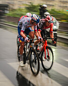 Paris, France - 27 July 2025: View of cyclists of the Tour de France 2025 speeding through the city streets, a blur of vibrant colors against the grey asphalt, capturing the intensity of the Tour de France 2025.