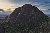 Aerial view of the stark, imposing bulk of the Cerros de Mavecure monoliths rises out of the emerald jungle, a symphony of shadow and light, Guainia, Guainía, Colombia.