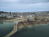 Aerial view of the Tour Solidor standing proudly against the sea, connected by a narrow causeway amidst the vast coastal landscape, Saint-Malo, Bretagne, France.
