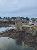 Aerial view of the rugged coastline embracing the ancient fortress of La Tour Solidor under a brooding sky, Saint-Malo, Bretagne, France.