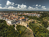 Aerial view of the Castello Aragonese perched majestically above the Adriatic, its stone walls contrasting with the vibrant green foliage, Ortona, Abruzzo, Italy.
